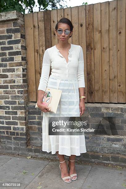Lauren Preston of Burberry New York wears Burberry Prorsum dress, Saint Lauren shoes, Stella McCartney purse and Dior sunglasses on day 4 of London...