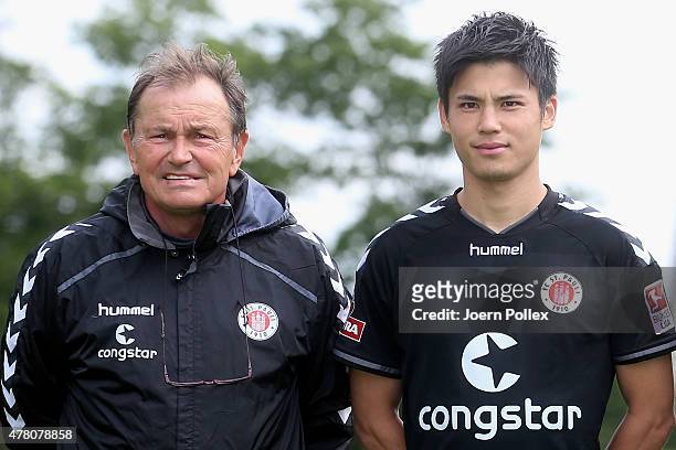 St. Pauli Football Club's new signing Ryo Miyaichi and head coach Ewald Lienen pose for a photograph following his transfer on June 22, 2015 in...