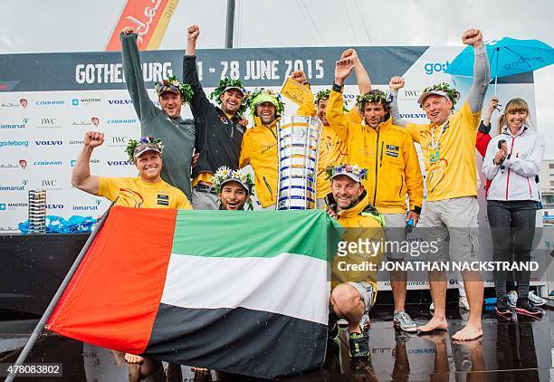 Abu Dhabi Ocean Racing team skippered by English Ian Walker celebrates during the winners ceremony after arriving in Gothenburg at the end of Leg 9...