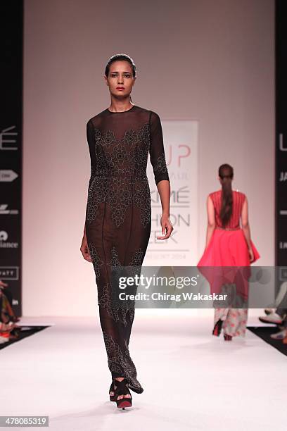 Model walks the runway wearing designs by Sougat Paul at day 2 of Lakme Fashion Week Summer/Resort 2014 at the Grand Hyatt on March 12, 2014 in...