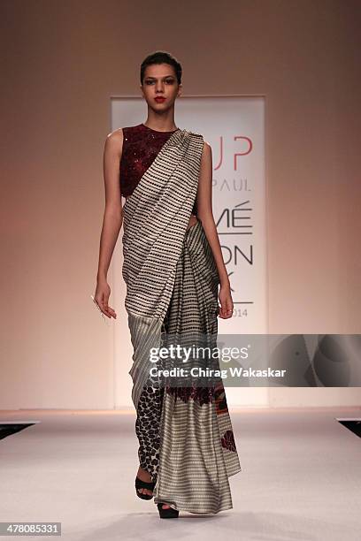 Model walks the runway wearing designs by Sougat Paul at day 2 of Lakme Fashion Week Summer/Resort 2014 at the Grand Hyatt on March 12, 2014 in...