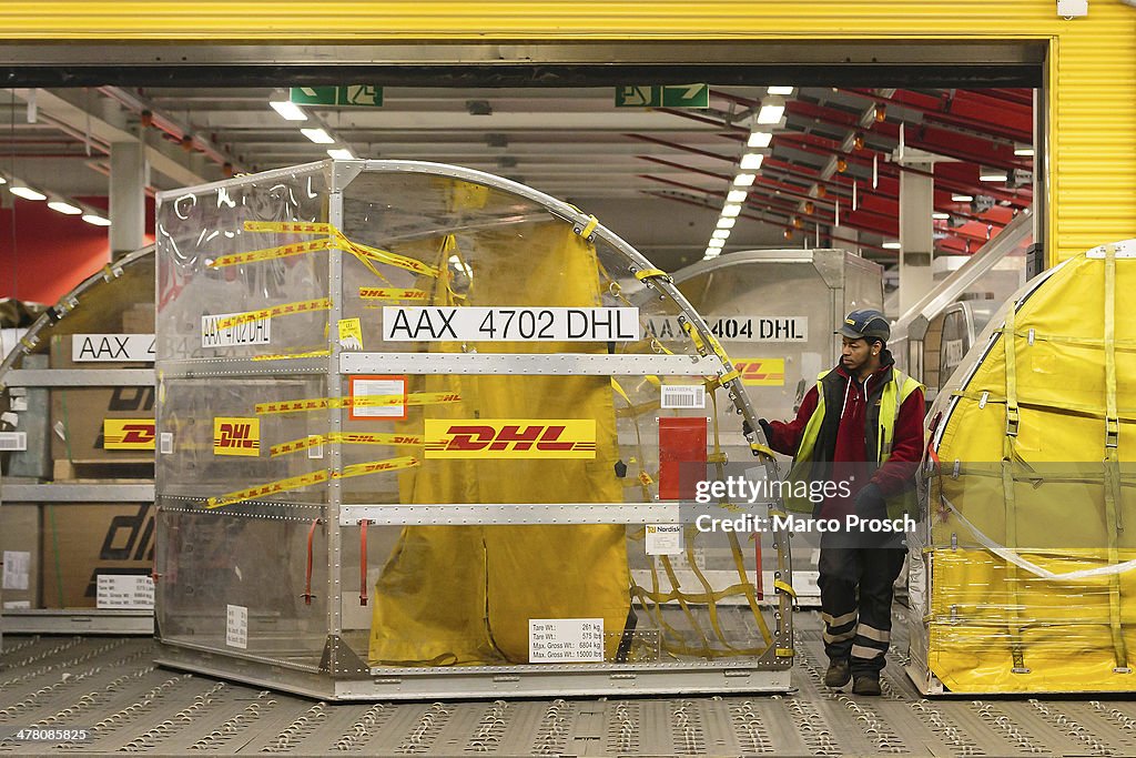 Lay Dhl A worker handles a ULD cargo container during the night at the DHL ...