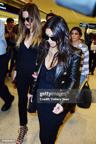 Khloe Kardashian, Kim Kardashian and Kourtney Kardashian seen at International Airport on March 11, 2014 in Miami Beach, Florida.