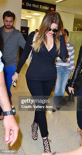 Scott Disick, Khloe Kardashian and Kourtney Kardashian seen at International Airport on March 11, 2014 in Miami Beach, Florida.