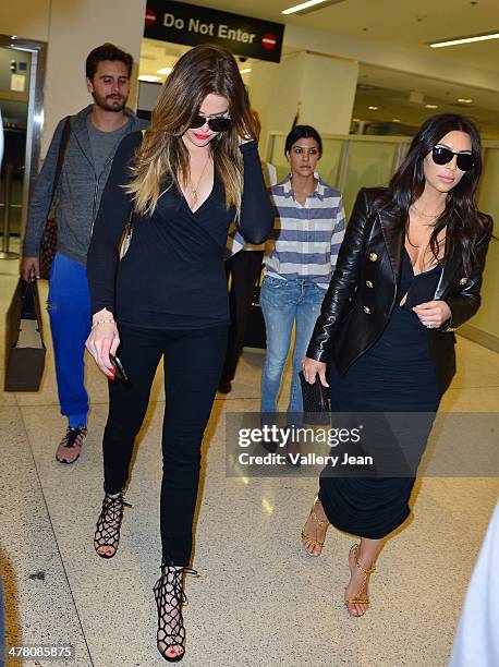 Scott Disick, Khloe Kardashian, Kourtney Kardashian and Kim Kardashian seen at International Airport on March 11, 2014 in Miami Beach, Florida.