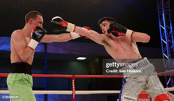 Ryan Wheeler of England and Janis Puksins of Latvia exchange blows during their Super Featherweight bout at Action Indoor Sports Arena on June 13,...