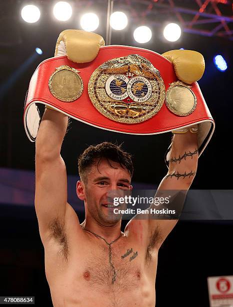 Lee Haskins of Great Britain celebrates with the IBF World Bantamweight title belt after defeating Ryosuke Iwasa of Japan in their Interim IBF World...