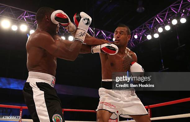 Bob Ajisafe of Great Britain and Daniel Wanyonyi of Kenya exchange blows during their Commonwealth Leight-Heavyweight Title Fight at Action Indoor...