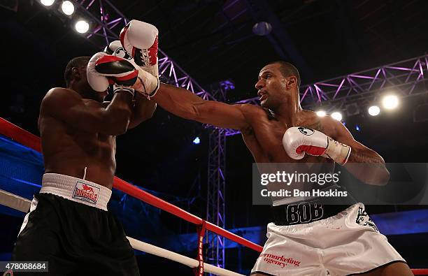 Bob Ajisafe of Great Britain and Daniel Wanyonyi of Kenya exchange blows during their Commonwealth Leight-Heavyweight Title Fight at Action Indoor...