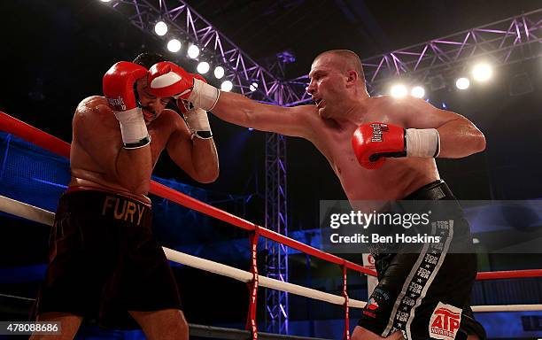 Young Fury of Great Britain and Jindrich Velecky of Czech Republic exchange blows during their Heavyweight bout at Action Indoor Sports Arena on June...