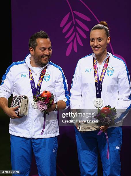 Silver medalists Konstantinos Malgarinos and Anna Korakaki of Greece pose with the medals won during the Shooting Mixed Team 10m Air Pistol finals on...