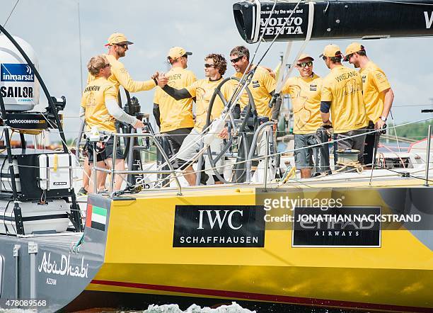 Abu Dhabi Ocean Racing team skippered by British Ian Walker celebrate as the arrive in Gothenburg at the end of Leg 9 of the Volvo Ocean Race from...
