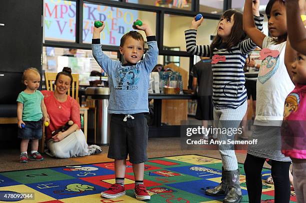 Keenan Klepper dances with shakers alongside his sister, MaKenna Klepper right, during story time at Philip S. Miller Library on June 11 in Castle...