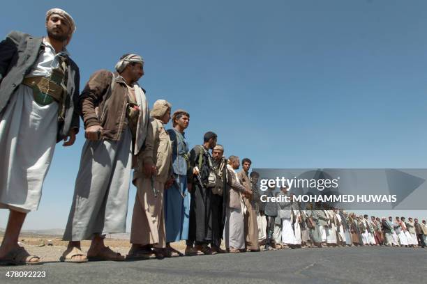 Tribesmen loyal to the Shiite Muslim Huthi movement hold their weapons as they gather in Haz, west of the Yemeni capital Sanaa, on March 12, 2014....