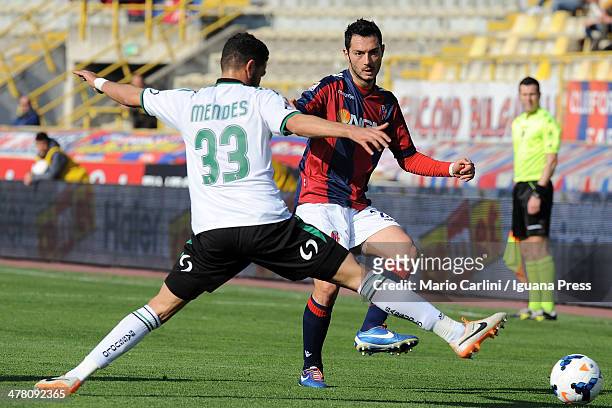 Andrea Mantovani of Bologna FC kicks the ball past Pedro Mendes of US Sassuolo Calcio during the Serie A match between Bologna FC and US Sassuolo...