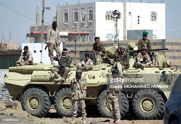 Yemeni army soldiers stand guard as tribesmen from the Shiite Muslim Huthi movement gather in Haz, west of the Yemeni capital Sanaa, on March 12,...