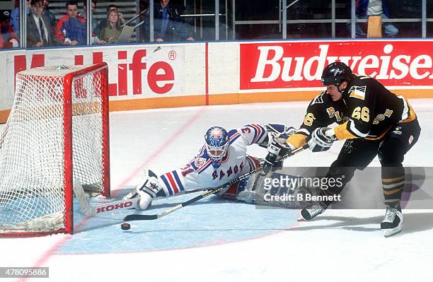 Mario Lemieux of the Pittsburgh Penguins is stopped by Corey Hirsch of the New York Rangers on January 1, 1980 at Madison Square Garden in New York,...
