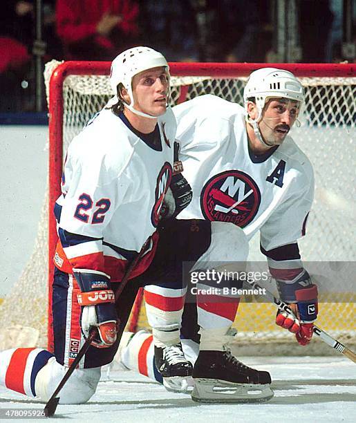 Mike Bossy and Bryan Trottier of the New York Islanders take a break during a game at the Nassau Coliseum in Uniondale, New York.