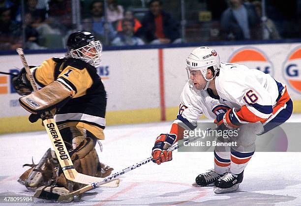 Wendel Young of the Pittsburgh Penguins looks to make a save on Pat Lafontaine of the New York Islanders on January 1, 1980 the the Nassau Coliseum...
