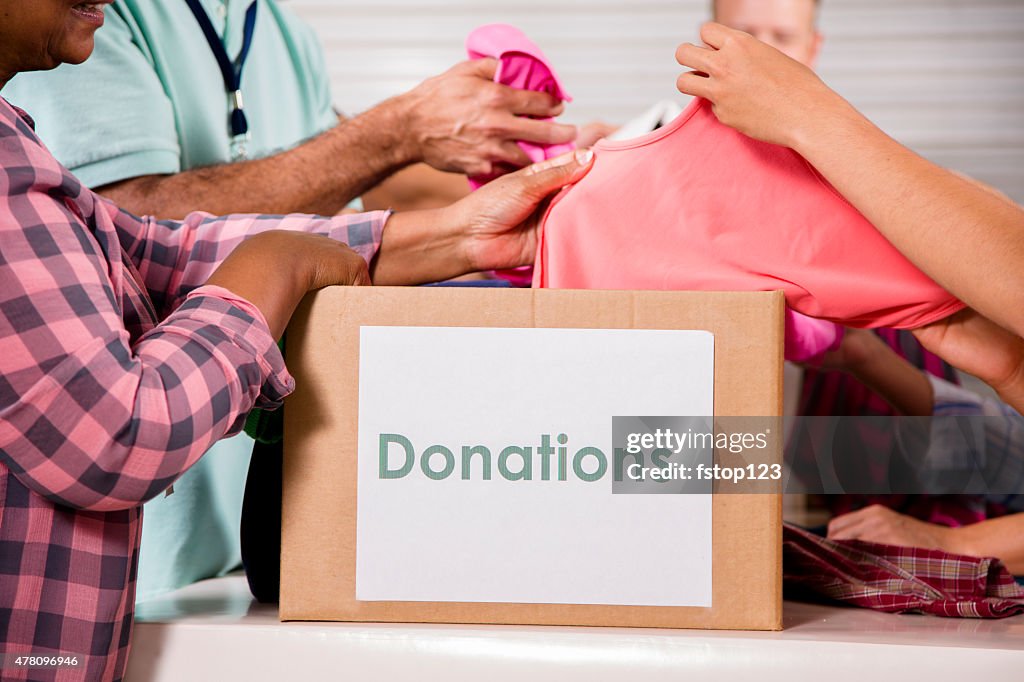 Group of volunteers provide clothing donations to needy families. Charity.