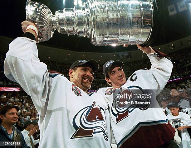 Ray Bourque of the Colorado Avalanche lifts the cup with Joe Sakic after the Colorado Avalanche defeated the New Jersey Devils 3-1 in game seven of...