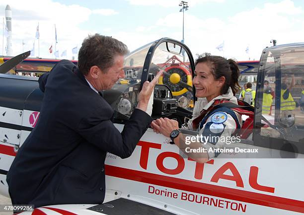 Pilot Dorine Bourneton celebrates with Gilles Furnier, General Manager of the Paris Air Show, after taking part in the first worldwide aerobatic show...