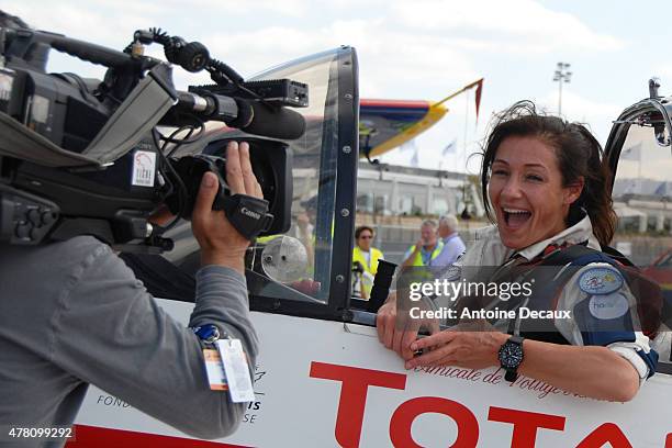 Pilot Dorine Bourneton celebrates, after taking part in the first worldwide aerobatic show performed by a paraplegic woman, at the Paris Air Show...