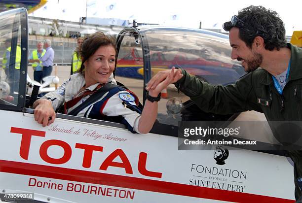 Pilot Dorine Bourneton celebrates with her physical and mental trainer, Samuel Degoute, after taking part in the first worldwide aerobatic show...