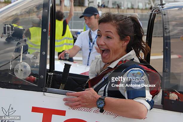 Pilot Dorine Bourneton celebrates after taking part in the first worldwide aerobatic show performed by a paraplegic woman, at the Paris Air Show 2015...