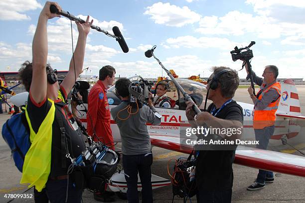 Pilot Dorine Bourneton is interviewed after taking part in the first worldwide aerobatic show performed by a paraplegic woman, at the Paris Air Show...