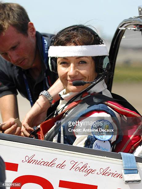 Pilot Dorine Bourneton is secured to her seat before taking part in the first worldwide aerobatic show performed by a paraplegic woman, at the Paris...