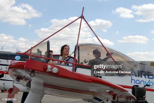 Pilot Dorine Bourneton looks up at the sky before taking part in the first worldwide aerobatic show performed by a paraplegic woman, at the Paris Air...
