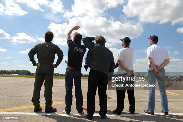 Dorine Bourneton's crew watch as the first worldwide aerobatic show performed by a paraplegic woman takes place at the Paris Air Show 2015 in Le...
