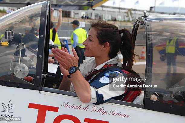 Pilot Dorine Bourneton celebrates after taking part in the first worldwide aerobatic show performed by a paraplegic woman, at the Paris Air Show 2015...