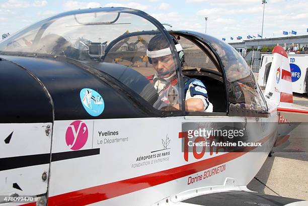 Pilot Dorine Bourneton concentrates before taking part in the first worldwide aerobatic show performed by a paraplegic woman, at the Paris Air Show...
