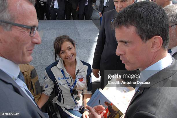 Pilot Dorine Bourneton gives her last book "Au Dessus Des Nuages" to the France Prime Minister, Manuel Walls, before taking part in the first...