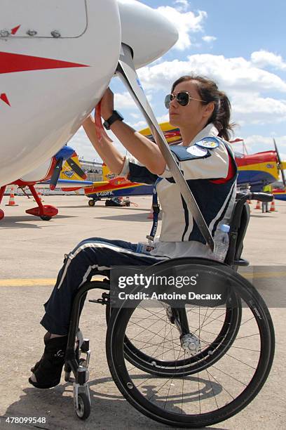 Pilot Dorine Bourneton performs the preflight inspection of her CAP 10 aircraft, before taking part in the first worldwide aerobatic show performed...