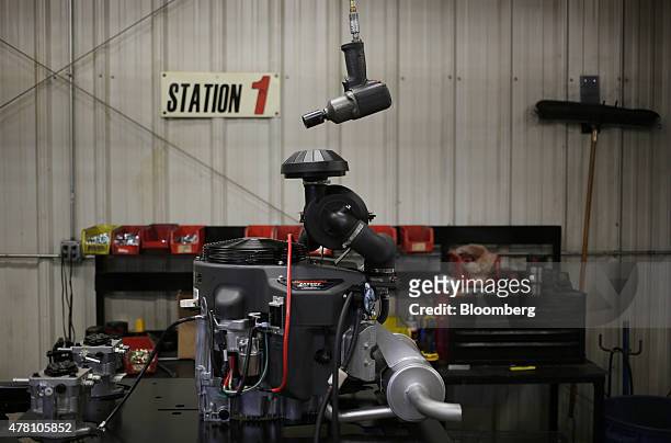 Kawasaki engine sits on a work station before being installed in a lawnmower at the Dixie Chopper manufacturing facility in Coatesville, Indiana,...