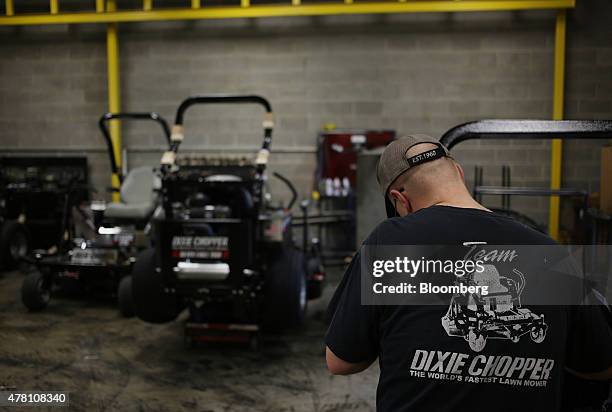 Worker performs a final inspection on completed lawnmowers at the Dixie Chopper manufacturing facility in Coatesville, Indiana, U.S., on Friday, June...