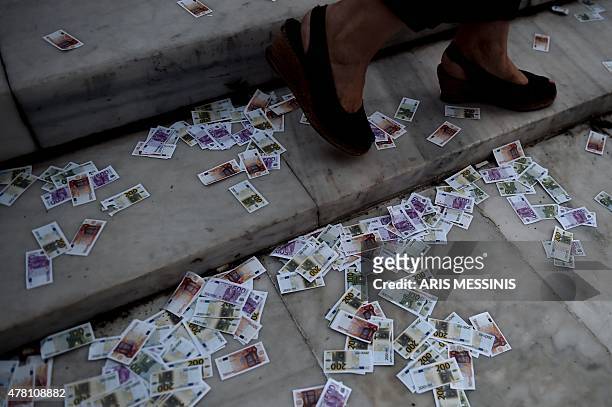 Fake euro currency are thrown on the ground during a pro-European demonstration in front of the Greek parliament in Athens on June 22, 2015. Greece's...