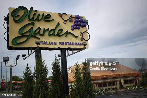 Darden Restaurants Inc. Olive Garden signage stands outside of a location in Louisville, Kentucky, U.S., on Monday, June 22, 2015. Darden Restaurants...
