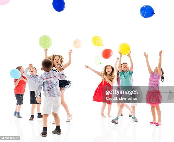 cheerful group of children playing with balloons. - child white background stock pictures, royalty-free photos & images