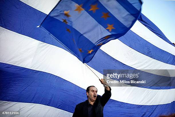 Man waves a EU flag as pro-Euro protesters take part in a rally in front of the Parliament on June 22. 2015 in Athens, Greece. Thousends of people...