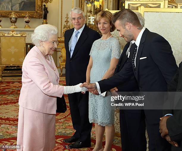 Queen Elizabeth II meets David Beckham at a reception at Buckingham Palace to celebrate The Queen's Young Leaders programme and present awards to the...