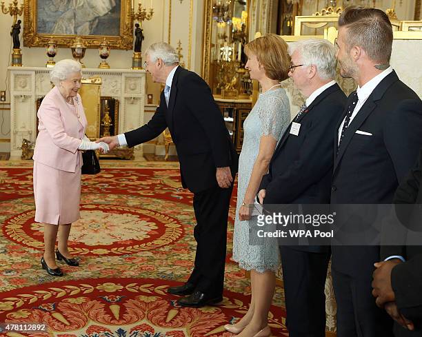 Queen Elizabeth II greets to guest including Sir John Major, David Beckham and Steve McQueen at a reception at Buckingham Palace to celebrate The...