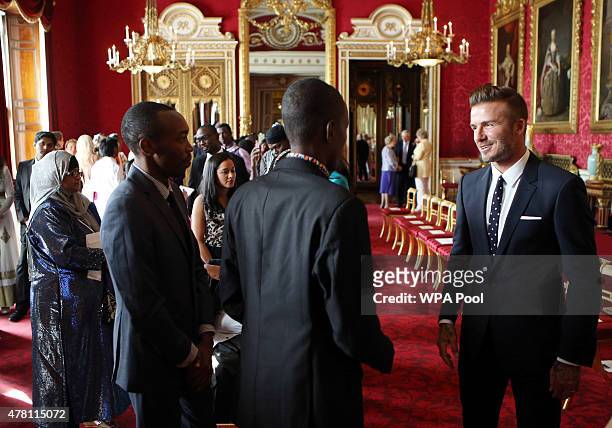 David Beckham talks to guests at a reception at Buckingham Palace to celebrate The Queen's Young Leaders programme and present awards to the first...