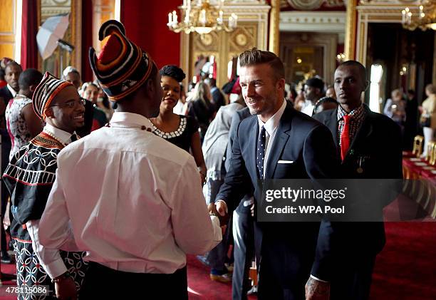 David Beckham talks to guests at a reception at Buckingham Palace to celebrate The Queen's Young Leaders programme and present awards to the first...