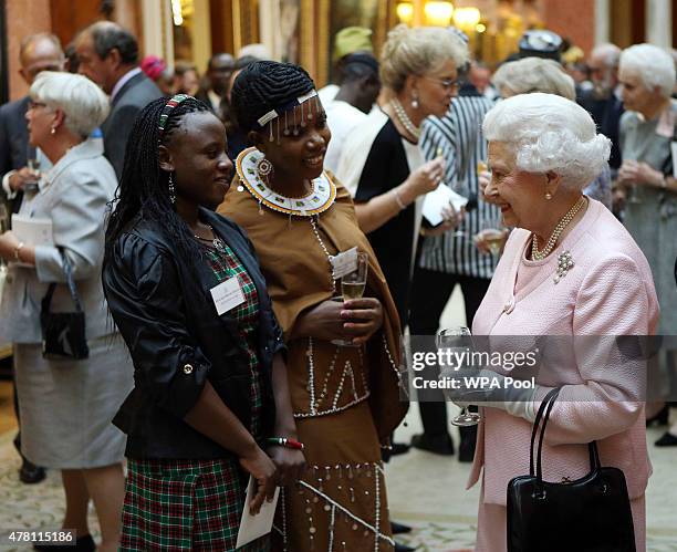 Queen Elizabeth II talks to guests at a reception at Buckingham Palace to celebrate The Queen's Young Leaders programme and present awards to the...