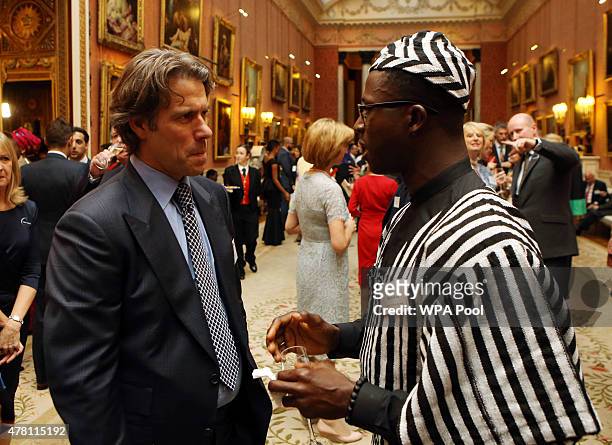 John Bishop talks to guests at a reception at Buckingham Palace to celebrate The Queen's Young Leaders programme and present awards to the first...