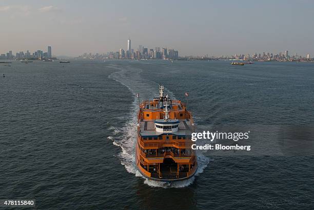 The Staten Island Ferry moves across the Upper Bay in this aerial photograph taken above New York, U.S., on Wednesday, June 10, 2015. U.S. Stocks...